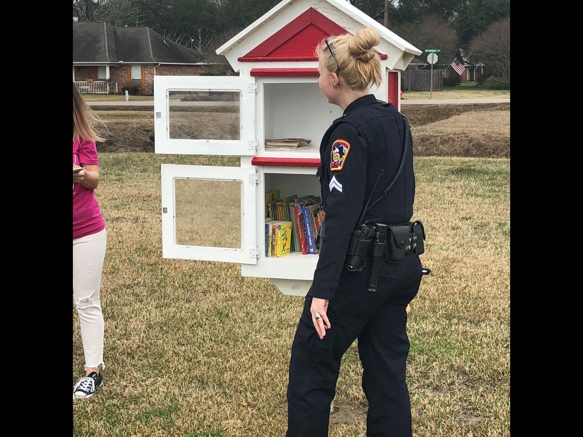 Police officer at little library box
