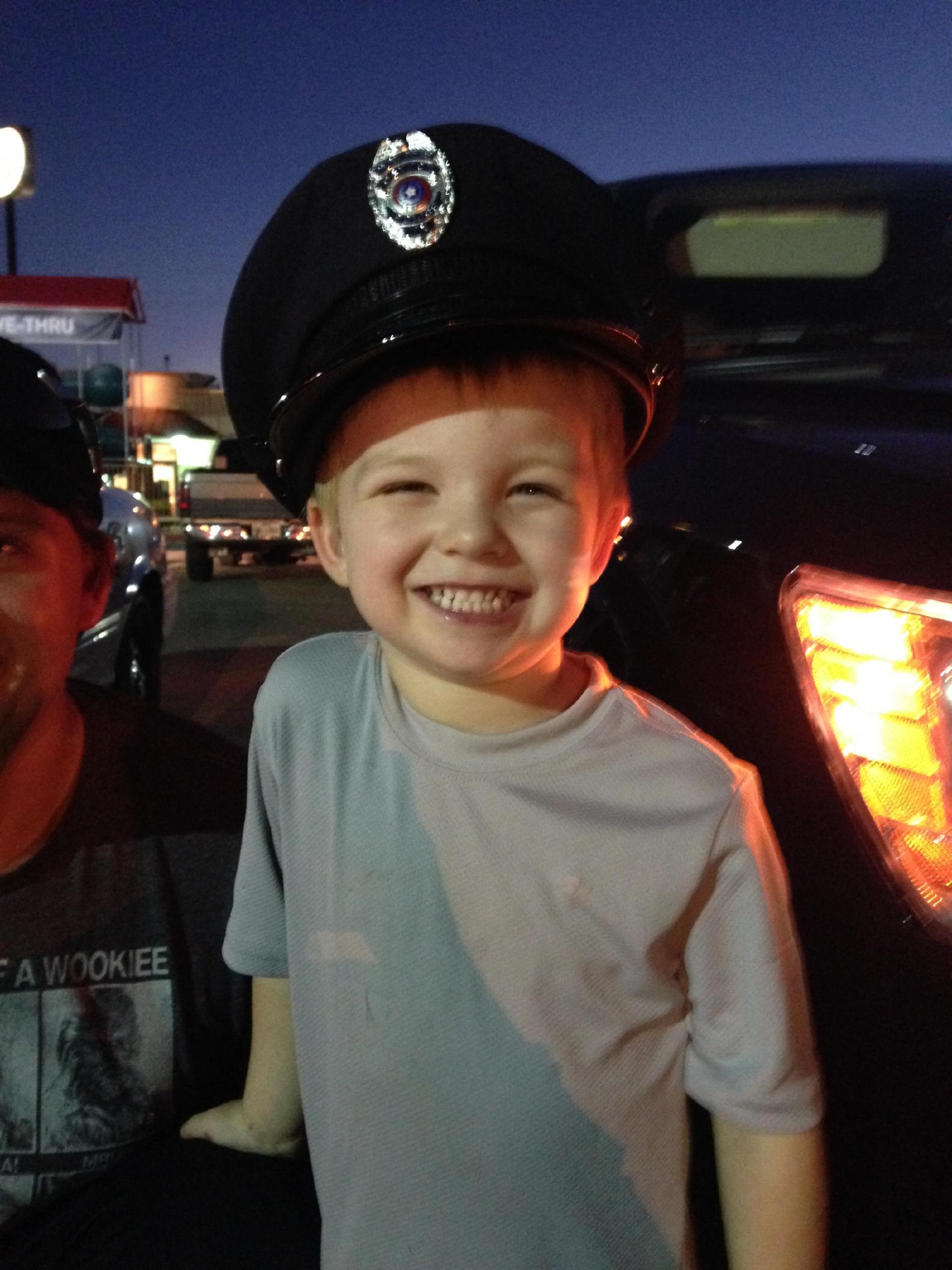 Kid in police officer's hat